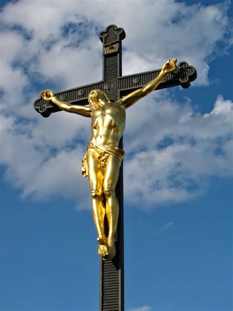 Golden crucifix against the sky